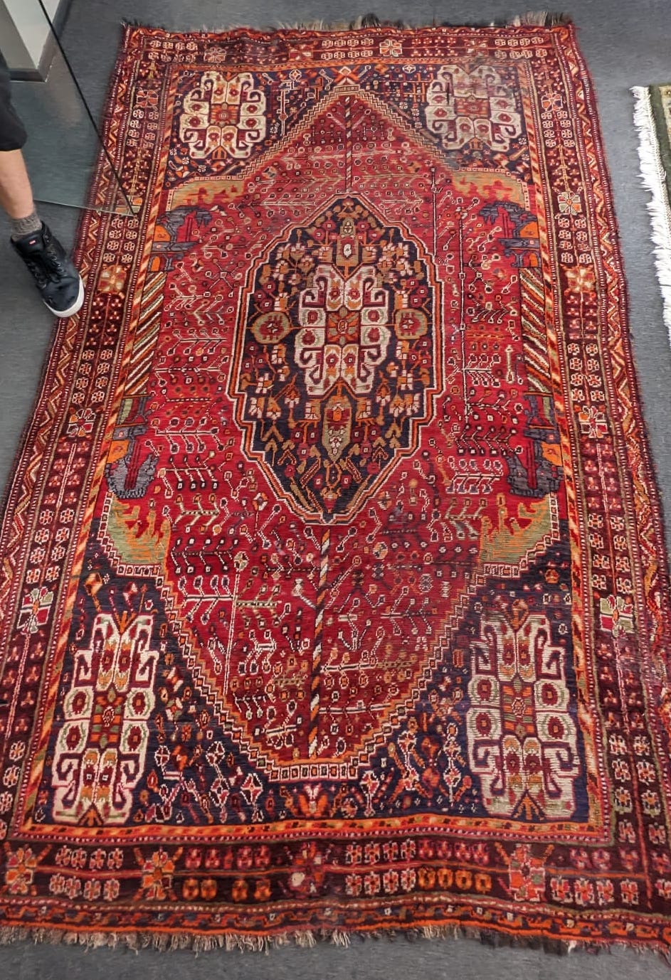 A Caucasian red ground carpet 260cm x 160cm.